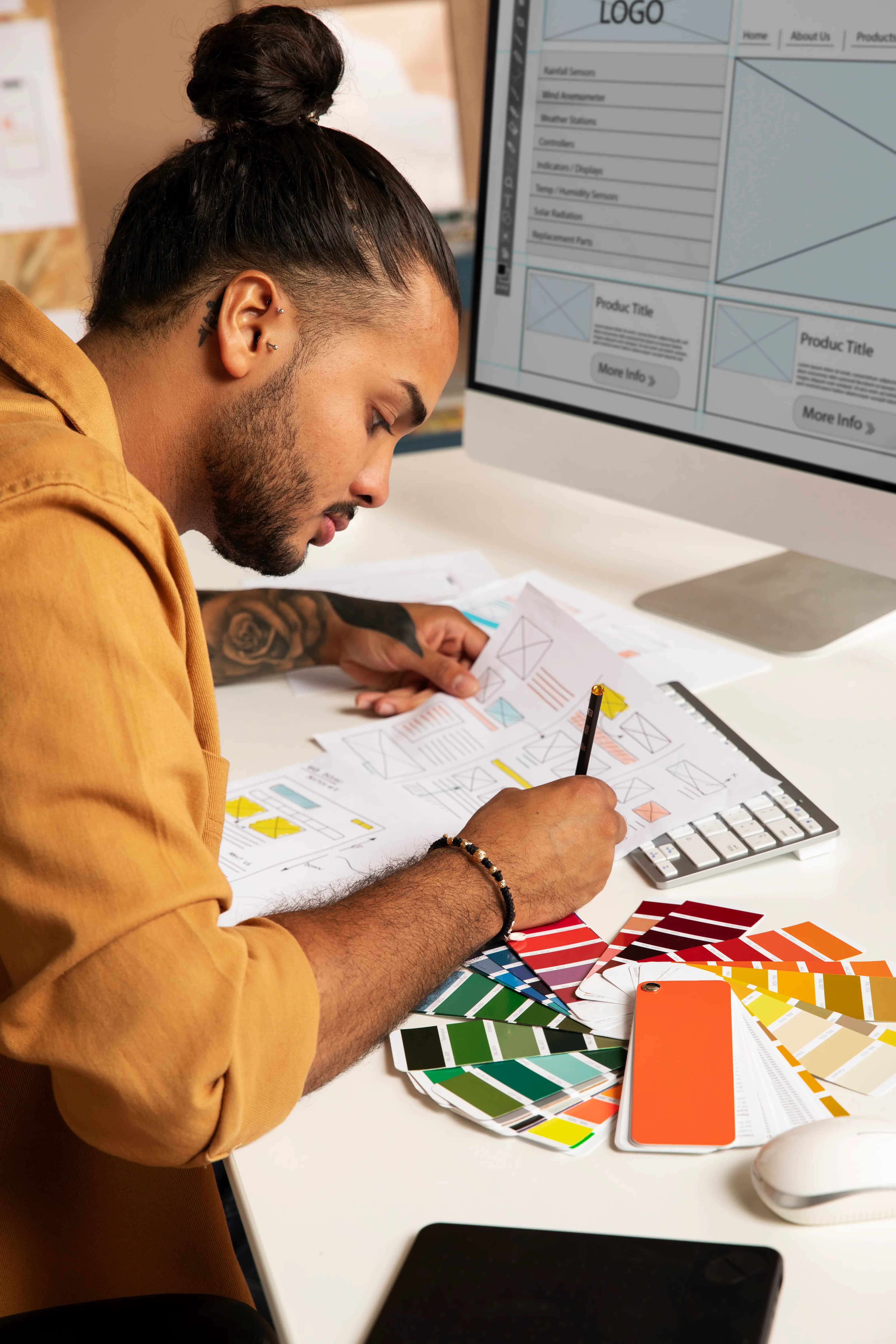 A Web&Buzz designer reviewing wireframes and brand color options during a strategy session